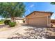 Single-story home featuring a two-car garage, a long driveway and low-maintenance landscaping at 30212 N Sunray Dr, San Tan Valley, AZ 85143