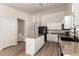 Spacious kitchen with granite counters, a kitchen island, and black appliances at 30212 N Sunray Dr, San Tan Valley, AZ 85143
