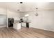 Bright kitchen featuring white cabinetry, black appliances, an island, and an open layout at 30212 N Sunray Dr, San Tan Valley, AZ 85143