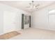 Bright living room featuring neutral carpet, a ceiling fan, and a front door at 30212 N Sunray Dr, San Tan Valley, AZ 85143