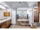 Bright bathroom featuring a soaking tub, marble counters, stained glass window, and walk-in shower at 322 E Gary Cir, Mesa, AZ 85201