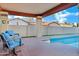 Relax on the covered patio with comfortable seating and views of the sparkling pool at 322 E Gary Cir, Mesa, AZ 85201