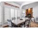 Bright dining room with fireplace, a decorative window and large table at 322 E Gary Cir, Mesa, AZ 85201