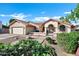 Inviting single-story home boasting a terra cotta roof, two-car garage, and lush front yard landscaping at 322 E Gary Cir, Mesa, AZ 85201