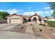 Charming single-story home with a terra cotta roof, a two-car garage, and a well-manicured landscaped front yard at 322 E Gary Cir, Mesa, AZ 85201