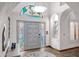 Bright foyer featuring tile floors, an art glass transom window, and a stylish front door with sidelights at 322 E Gary Cir, Mesa, AZ 85201