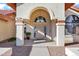 Elegant front entryway with decorative archway, columns, and a detailed front door at 322 E Gary Cir, Mesa, AZ 85201