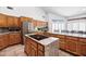 Kitchen featuring an island cooktop, stainless appliances, and wood cabinets at 322 E Gary Cir, Mesa, AZ 85201