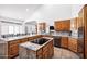 Open kitchen featuring a large island, wooden cabinets, and tiled floor at 322 E Gary Cir, Mesa, AZ 85201
