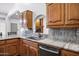 Updated kitchen featuring a kitchen sink, wooden cabinets, and granite counters at 322 E Gary Cir, Mesa, AZ 85201