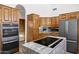 Kitchen with updated stainless appliances, granite countertops, and tiled floors at 322 E Gary Cir, Mesa, AZ 85201