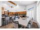 Open kitchen featuring wood cabinets, granite countertops, tile backsplash, and a large center island at 322 E Gary Cir, Mesa, AZ 85201