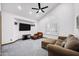 Bright living room features vaulted ceiling, comfortable seating and neutral carpeting at 322 E Gary Cir, Mesa, AZ 85201