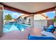 Outdoor living space with a covered patio offering stunning views of the sparkling swimming pool at 322 E Gary Cir, Mesa, AZ 85201
