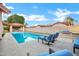 Relaxing backyard oasis features a sparkling pool, covered patio, grill, and lounge chairs at 322 E Gary Cir, Mesa, AZ 85201