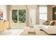Airy living room featuring an off-white sofa, minimalist decor, and bright natural light at 32229 N Garnet Way, San Tan Valley, AZ 85143