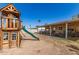 Beautiful backyard with a wooden playset and covered patio at 3256 W Libby St, Phoenix, AZ 85053