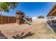 Spacious backyard featuring a wooden play structure with slide and swing for Gathering fun at 3256 W Libby St, Phoenix, AZ 85053