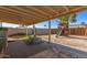 Spacious backyard featuring a wooden playhouse and covered patio area at 3256 W Libby St, Phoenix, AZ 85053