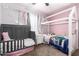 Pink bedroom with two beds, a nightstand, and natural light at 3256 W Libby St, Phoenix, AZ 85053