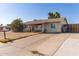 Front exterior showcases a single-story home with desert landscaping, a driveway, and a peaceful neighborhood setting at 3256 W Libby St, Phoenix, AZ 85053