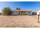 Inviting single-story home showcasing desert landscape and a cozy front porch, perfect for relaxing evenings at 3256 W Libby St, Phoenix, AZ 85053