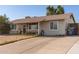 Inviting single-story home with desert landscaping, a cozy entrance, and a spacious driveway for easy parking at 3256 W Libby St, Phoenix, AZ 85053