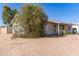 Side view of a cozy single-story home featuring desert landscaping, offering a peaceful and private setting at 3256 W Libby St, Phoenix, AZ 85053