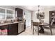 Bright kitchen and dining area with stainless steel dishwasher and stylish light fixture at 3256 W Libby St, Phoenix, AZ 85053