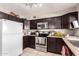 A functional kitchen design featuring stainless steel appliances and dark cabinets at 3256 W Libby St, Phoenix, AZ 85053