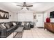 Inviting living room featuring tile flooring, a comfy sectional, and modern décor perfect for relaxed living and gatherings at 3256 W Libby St, Phoenix, AZ 85053