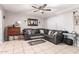 Stylish living room with tile flooring, a comfortable sectional, and decorative accents creating a warm ambiance at 3256 W Libby St, Phoenix, AZ 85053