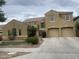Stunning two-story home features a spacious driveway, attached two-car garage, and desert landscaping at 3845 E Yeager Dr, Gilbert, AZ 85295