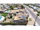 An aerial view of a residential area with multiple single-Gathering homes, showcasing pools, landscaping, and solar panels at 3848 W Kings Ave, Phoenix, AZ 85053