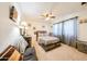 Comfortable bedroom featuring a decorative ceiling fan, carpeted floors and natural light at 3848 W Kings Ave, Phoenix, AZ 85053
