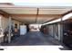 Spacious carport featuring a metal awning covering a long driveway, suitable for multiple vehicles at 3848 W Kings Ave, Phoenix, AZ 85053
