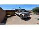 Spacious gravel driveway with a vintage truck parked, enhancing the property's curb appeal at 3848 W Kings Ave, Phoenix, AZ 85053