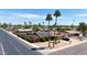 Corner lot home featuring solar panels, a desert front yard with palm trees, and mature landscaping at 3848 W Kings Ave, Phoenix, AZ 85053