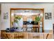 View of kitchen with wooden cabinets, black countertops, and pass-through to another room at 3848 W Kings Ave, Phoenix, AZ 85053