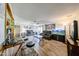 Gathering room with tile floors, comfortable reclining sofa, aquarium, ceiling fan, and bar seating at 3848 W Kings Ave, Phoenix, AZ 85053
