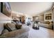 Open-concept living area featuring neutral decor, plush seating, and an inviting atmosphere at 3848 W Kings Ave, Phoenix, AZ 85053