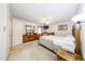 Spacious primary bedroom features carpeted floors, wood furniture, and a ceiling fan at 3848 W Kings Ave, Phoenix, AZ 85053