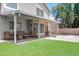 The covered patio features comfortable seating with lawn and mature landscaping in background at 3921 W Jasper Dr, Chandler, AZ 85226