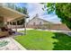 The covered patio overlooks a lush green lawn and mature landscaping at 3921 W Jasper Dr, Chandler, AZ 85226