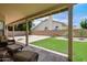 The covered patio overlooks a lush green lawn and mature landscaping at 3921 W Jasper Dr, Chandler, AZ 85226