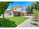 A spacious backyard featuring a covered patio, lawn, and mature landscaping at 3921 W Jasper Dr, Chandler, AZ 85226