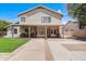 A spacious backyard featuring a covered patio, lawn, and mature landscaping at 3921 W Jasper Dr, Chandler, AZ 85226