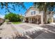 A spacious backyard featuring a large brick and concrete patio, lawn, and mature landscaping at 3921 W Jasper Dr, Chandler, AZ 85226