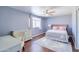 Bedroom featuring hardwood floors, a ceiling fan, a window and desk at 3921 W Jasper Dr, Chandler, AZ 85226