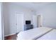 Bedroom with hardwood floors, TV, and a view to the hallway at 3921 W Jasper Dr, Chandler, AZ 85226